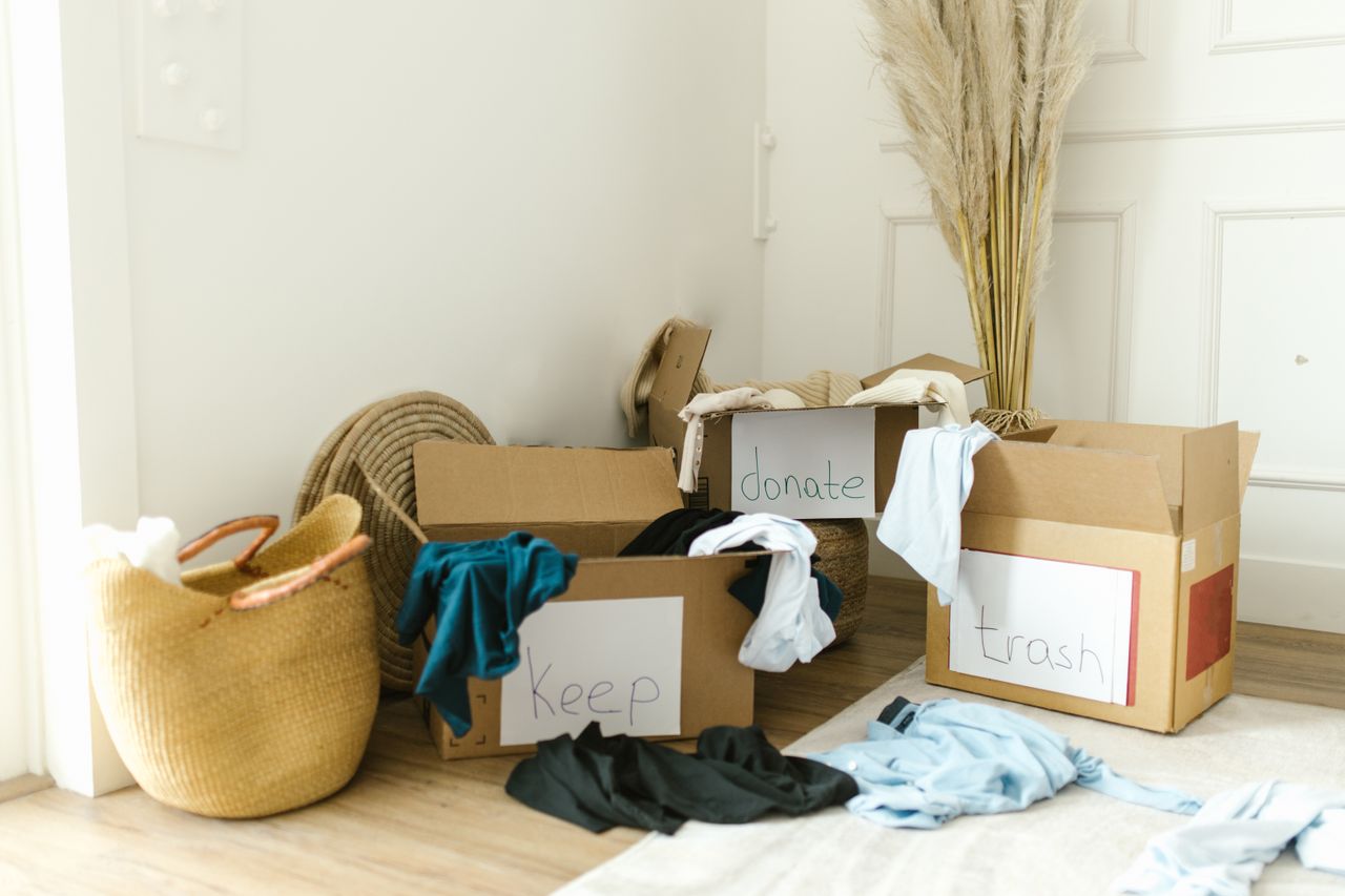 about-02 Cardboard boxes labeled Keep, Donate, and Trash for home decluttering.